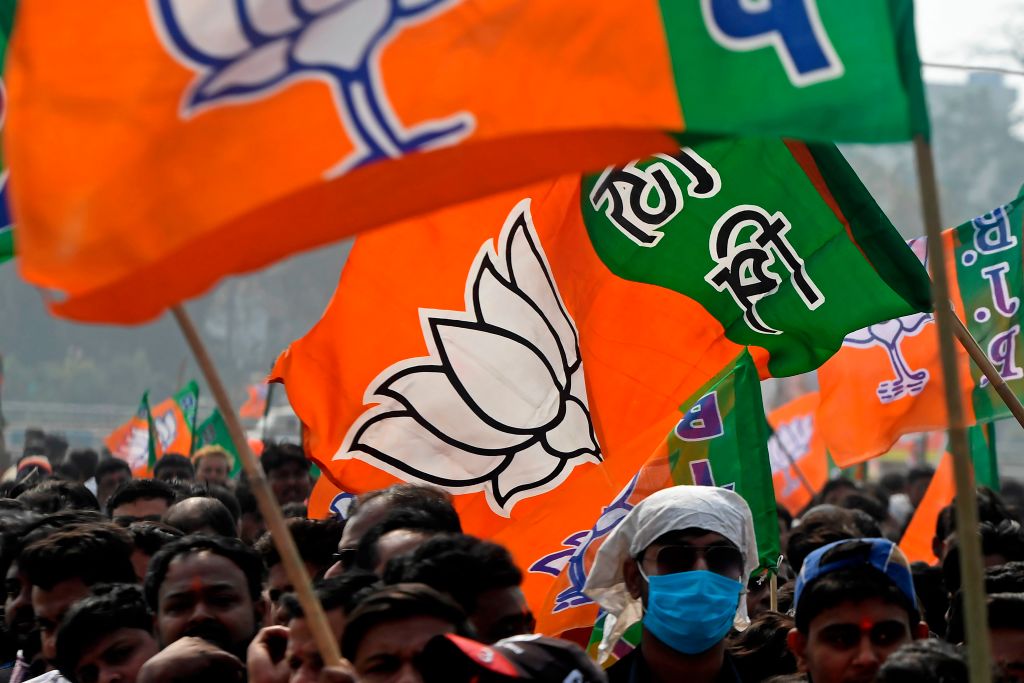 BJP supporters with party flags at a rally.