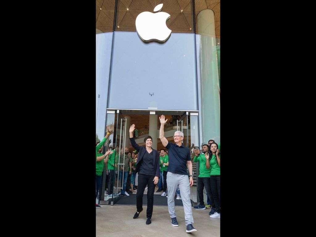 Apple CEO Tim Cook waves at the crowd during the opening of Apple's first retail store in India, in Mumbai