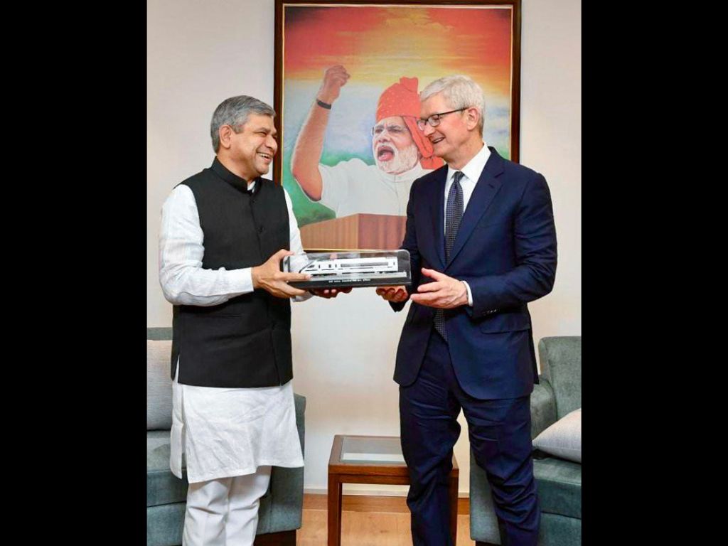 Indian railways minister Ashwini Vaishnaw (L) gifts Apple CEO Tim Cook a miniature replica of India's semi high-speed Vande Bharat Express train, in New Delhi