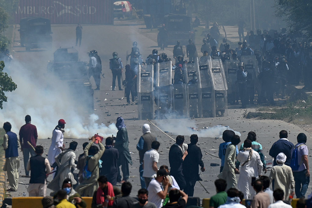 Pakistan Tehreek-e-Insaf (PTI) party activists and supporters of the country's former prime minister Imran Khan clash with policemen