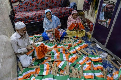Flag-makers Nissar Ahmad (L), with Farzana Ahmad (C) and Saeeda Banu make Indian Tricolours and pack them in bundles for sale ahead of the India's 75th Independence Day celebrations in Mumbai on August 9, 2021. (Photo by INDRANIL MUKHERJEE/AFP via Getty Images)